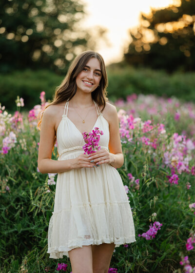 discovery park sweet pea wildflower fields senior girl in white dress at sunset