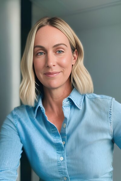 Woman wearing blue shirt looking to camera