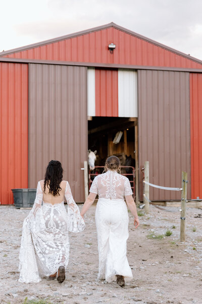Bride holding up a bouquet of flowers during a beach elopement in Michigan.