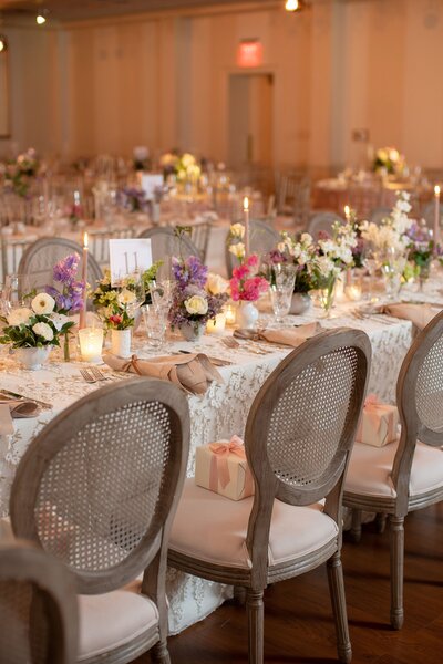Reception tables decorated with flower centerpieces for a wedding at Moraine Country Club