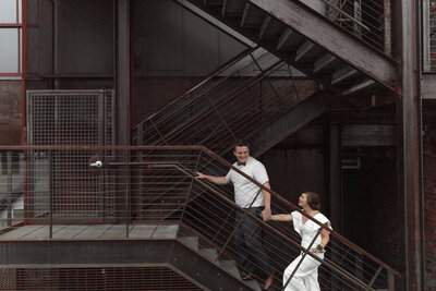 bride and groom walking up stairs