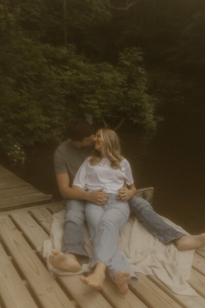 A couple sits together on a boat dock in rural Iowa.