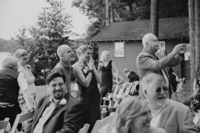 Guests smiling at bride walking down aisle during intimate backyard Denver wedding