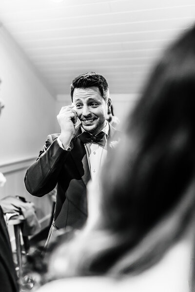 LGBTQ+  groom emotionally wiping tear during after the wedding ceremony