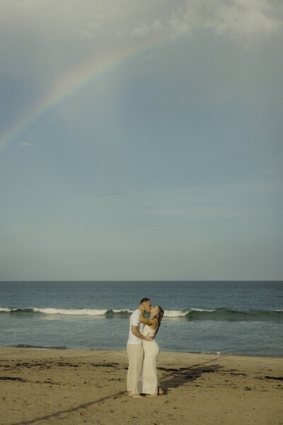 couple shares a kiss on beach