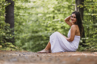 Girl sitting on ground in white dress | Senior Session