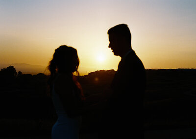 bride and groom at sunset on their wedding day