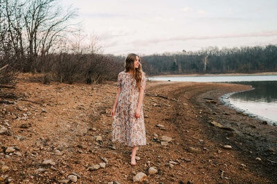 Springfield MO senior photography of teen girl looking at lake walking on rocks