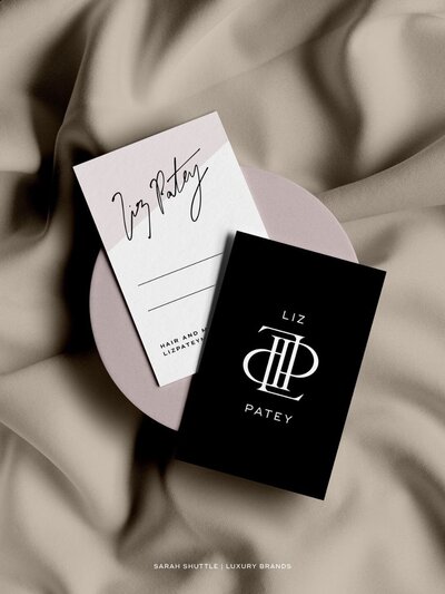 Black and blush pink business card design for Liz Patey luxury beauty brand on neutral silk fabric