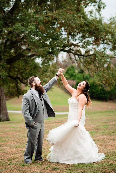 Bride and groom twirling outside