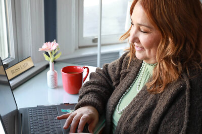 Kim chatting with a client on her lap top