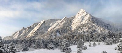 A fresh snow on the Flatirons mountains in Boulder, Colorado during sunrise