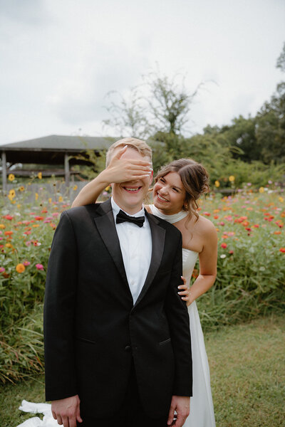Colorful Northwest Arkansas wedding photo of bride and groom in front of wildflowers 