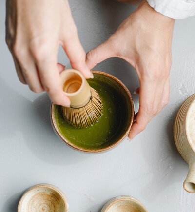 woman whisking matcha