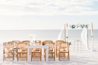 Beach wedding ceremony site that has wedding guests chairs