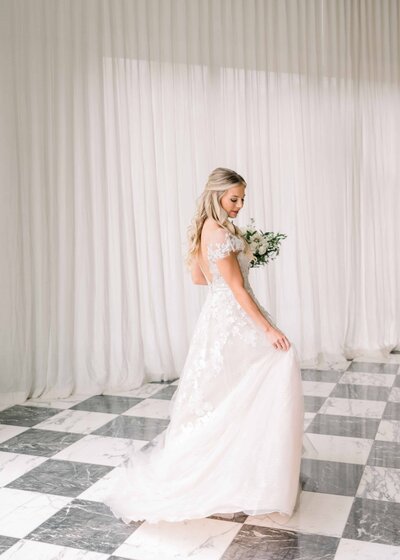 Bride twirling in room with checkered floor