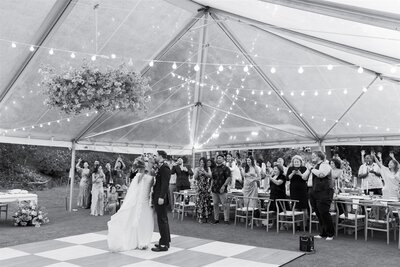 A newlywed couple dancing on a small dance floor during their reception 