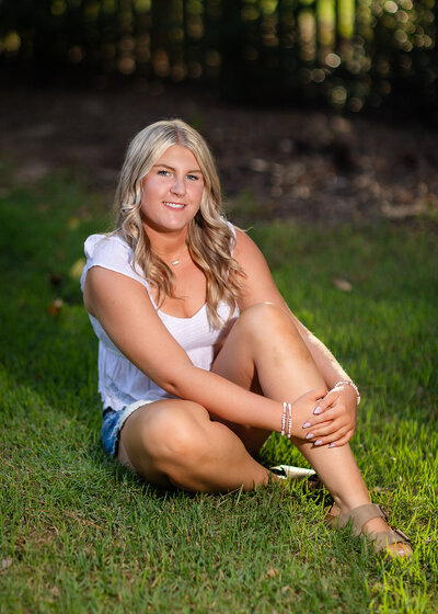 A girl posing for her senior portraits on the University of South Carolina's campus