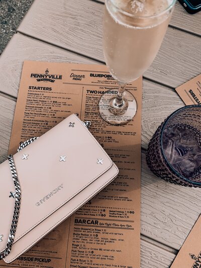 Photo of Menu, Handbag and glass of prosecco by AMALYN @amalynstyle @amalynsocial 