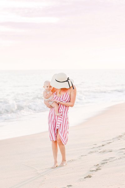 Mom walking down madaket beach holding her baby