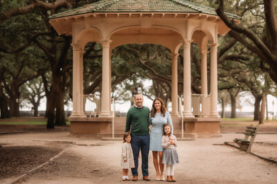 Family poses together in White Point Garden for their Family Pictures in Charleston, South Carolina.