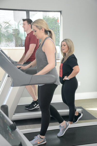 Britni with clients on treadmill