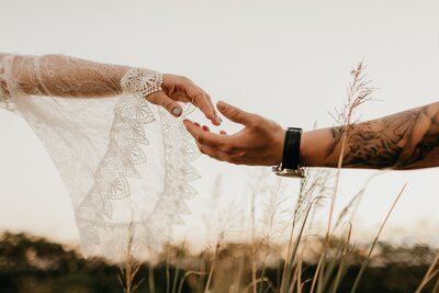 Couple holding hands on wedding day