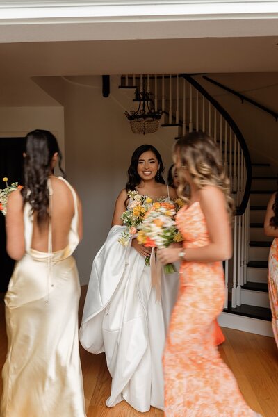 bride with bridesmaids walking around her to show top wedding planners in new york