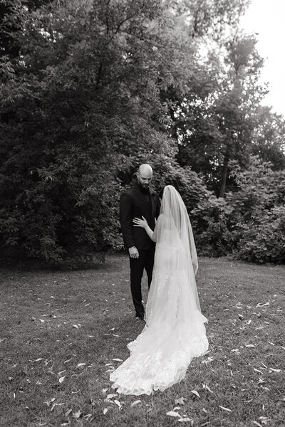 Bride and groom sharing a quiet moment beneath the trees during an Ottawa estate summer wedding — timeless, editorial wedding photography capturing natural connection.