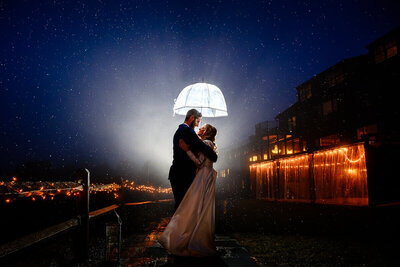 Mountain Top Resort couple with umbrella in the rain with fog