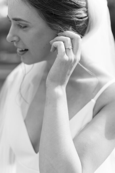 bride adjusting her earring