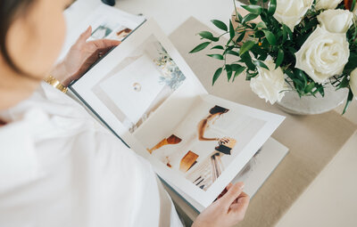 Woman's hand looking at a wedding album