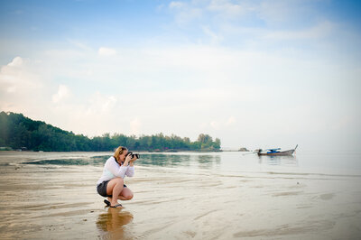 Tiffany Hix taking photos on a beach in Thailand