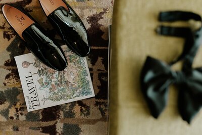shoes and travel magazine in flatlay