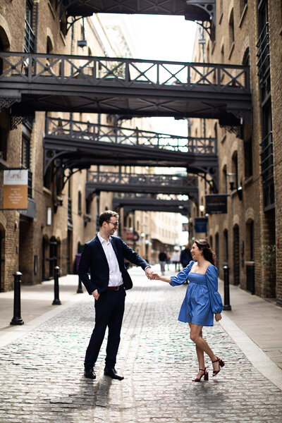 Engaged couple dancing in cobbled streets