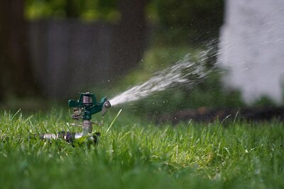 irrigation head spraying water on lawn
