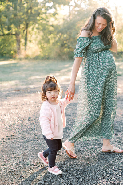 toddler holds moms hand during a Portland family maternity photography session