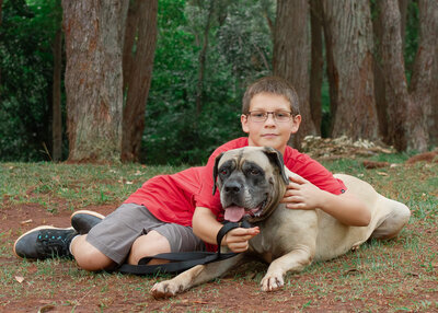 child hugs dog during family portraut session