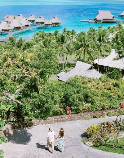 Aerial view on a couple in their overwater bungalow in Bora Bora