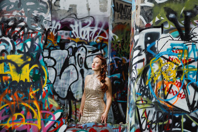 woman in gold dress with graffiti