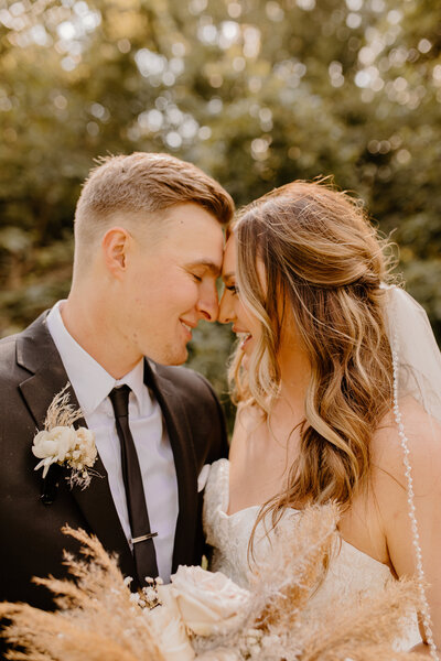 bride and groom close together with noses and foreheads