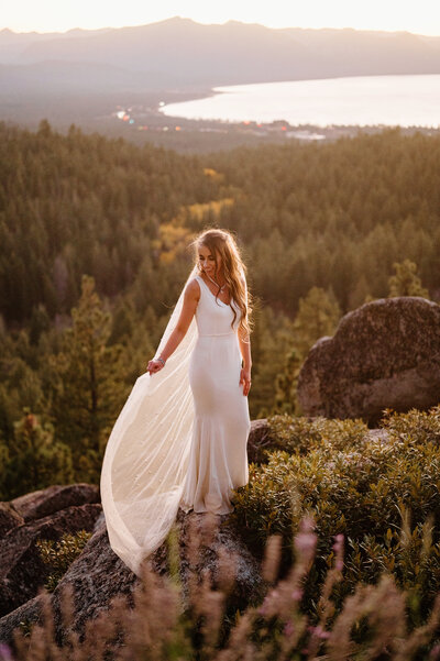 Bride on a cliff at sunset.