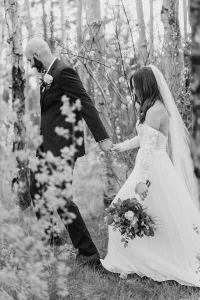 bride and groom under veil