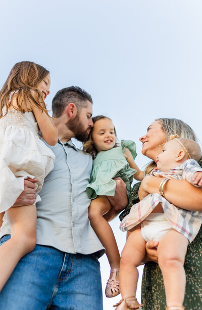 mom hugging her two daughters