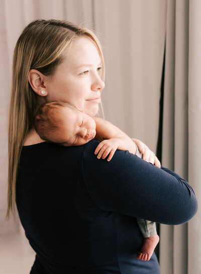A new mom snuggles her newborn baby boy. Diane Owen Photography.