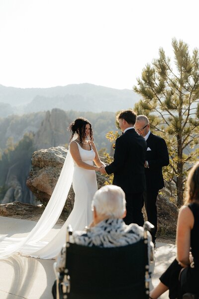 Luisa and Terrel smiling at each other at their elopement.