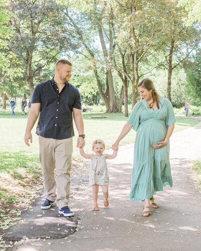family walking hand in hand down path