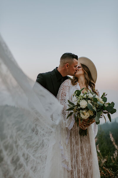 Couple sharing their first kiss on a mountain top on the Sunshine Coast B.C