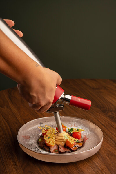 Chef Adriano Cappuzzello adding final touches to one of our incredible plate at Revé in Niagara