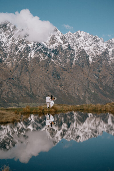 Bride and groom with mountains behind them at their Queenstown elopement